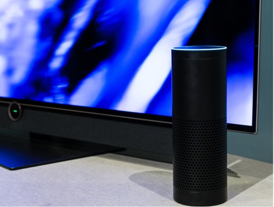 A speaker in front of a lit-up screen