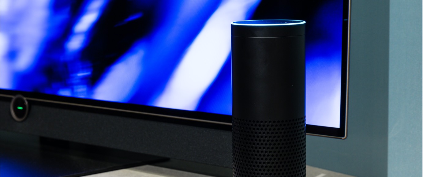 A speaker in front of a lit-up screen