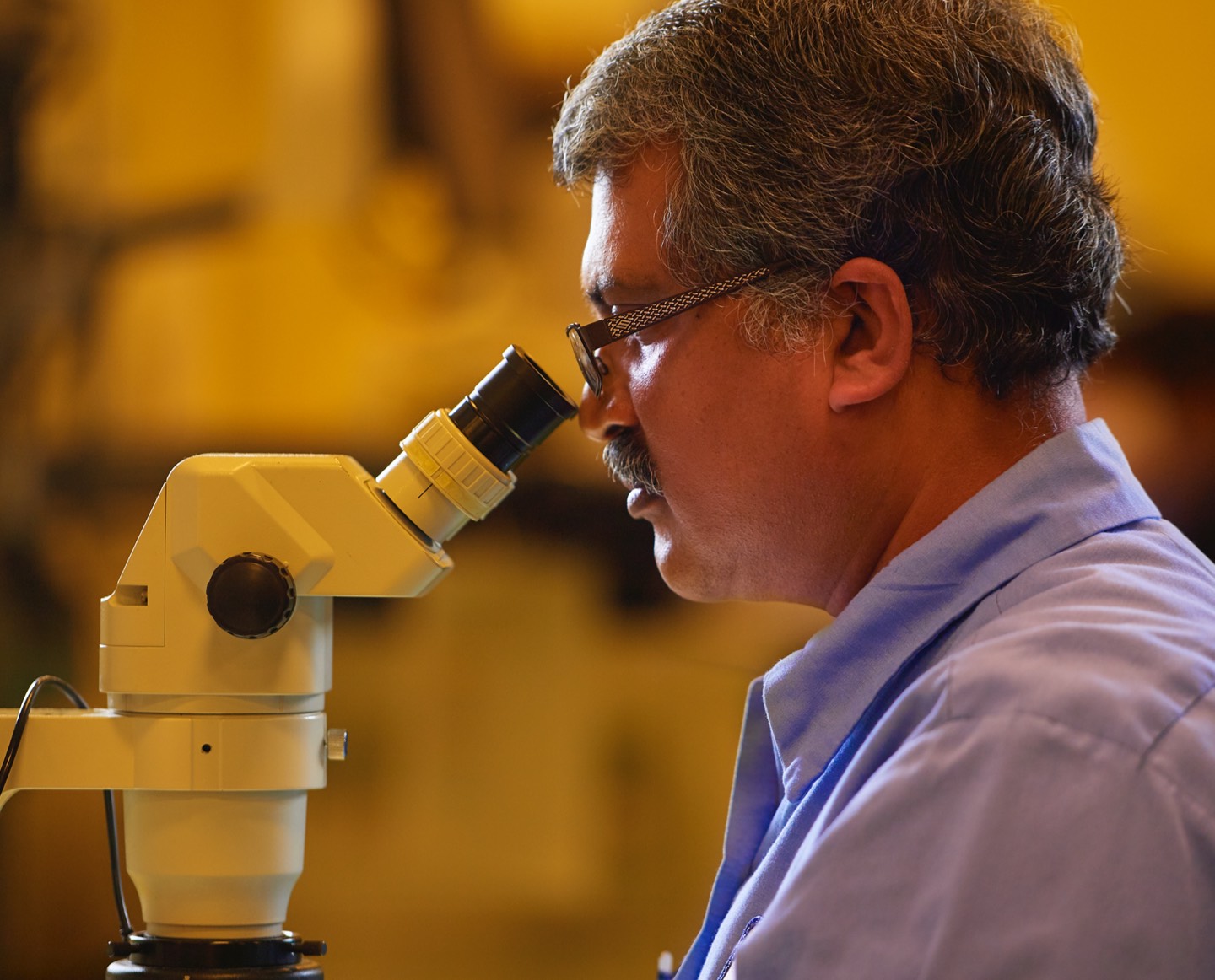 Close up of a man performing a Parts Inspection- desktop size