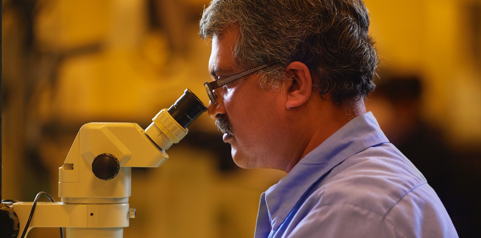 Close up photo of a man performing a Parts Inspection