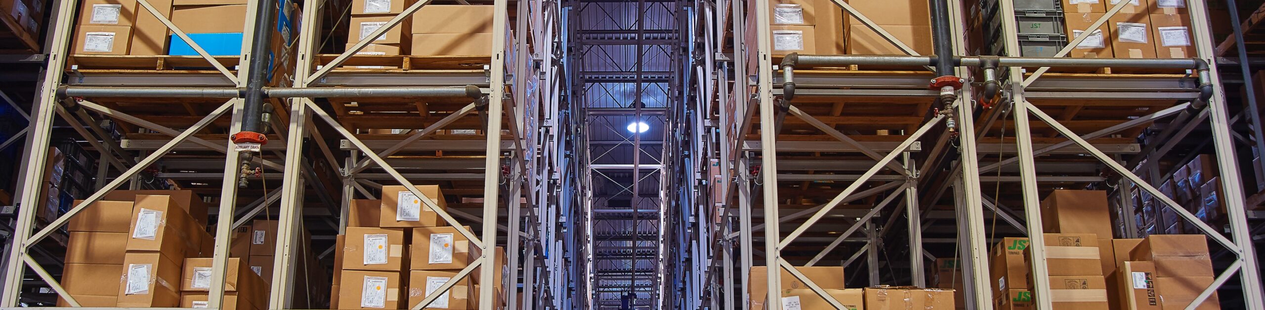 Boxes on large rows of shelving in the JST warehouse