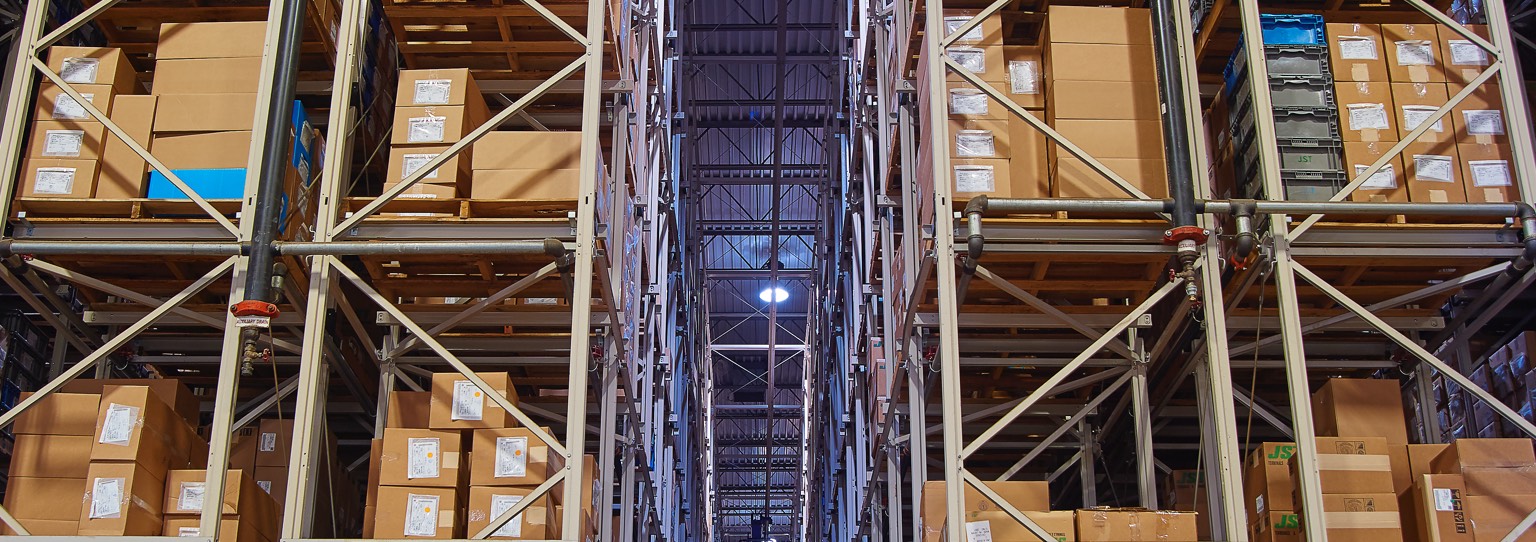 Boxes on large rows of shelving in the JST warehouse